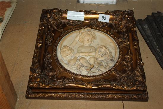 19th century Italian alabaster roundel, carved with three infaces, within a modern gilt frame